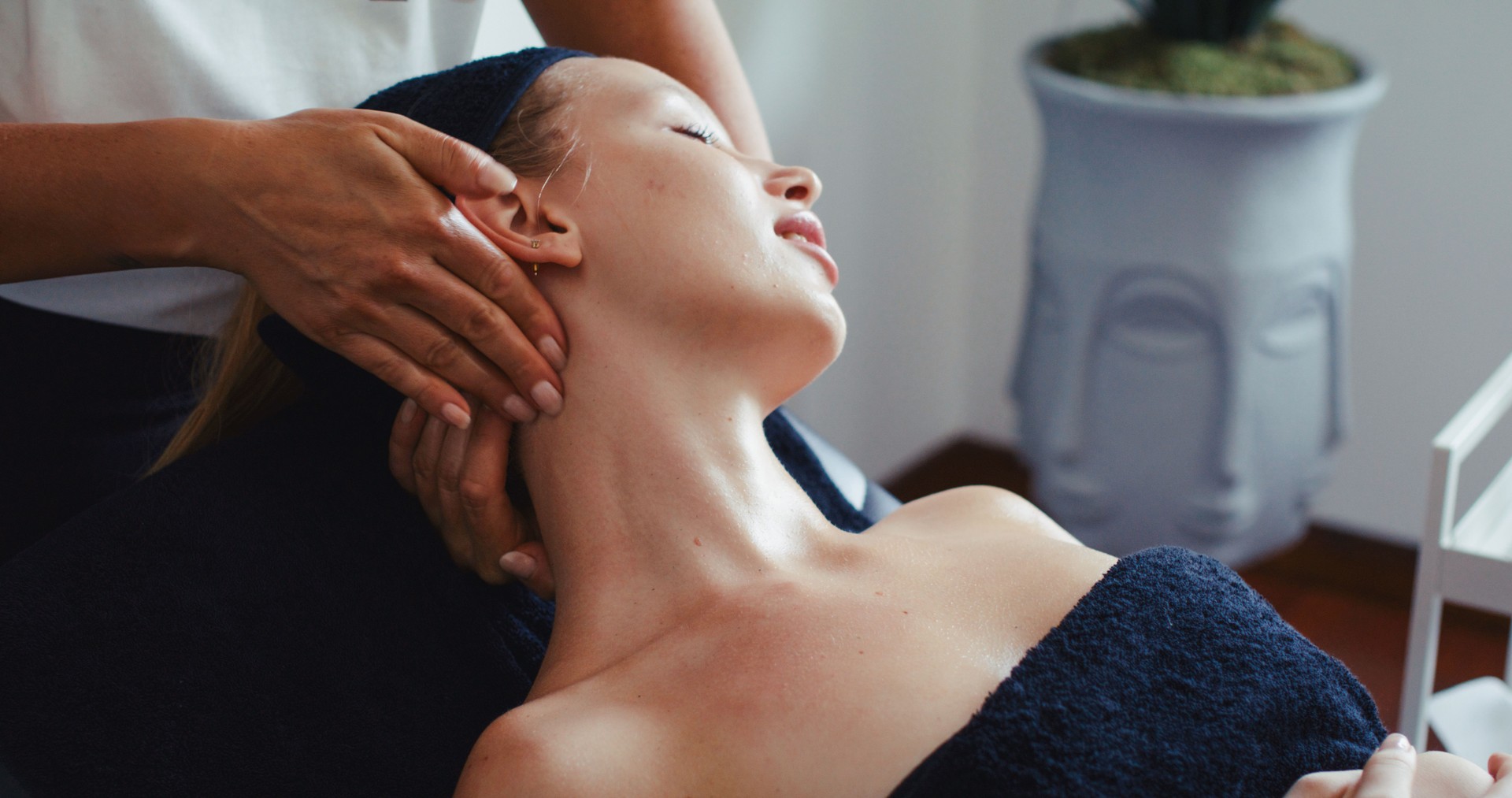 Beautiful young woman taking facial massage in spa. Concept for skin care, anti aging, and wellbeing.